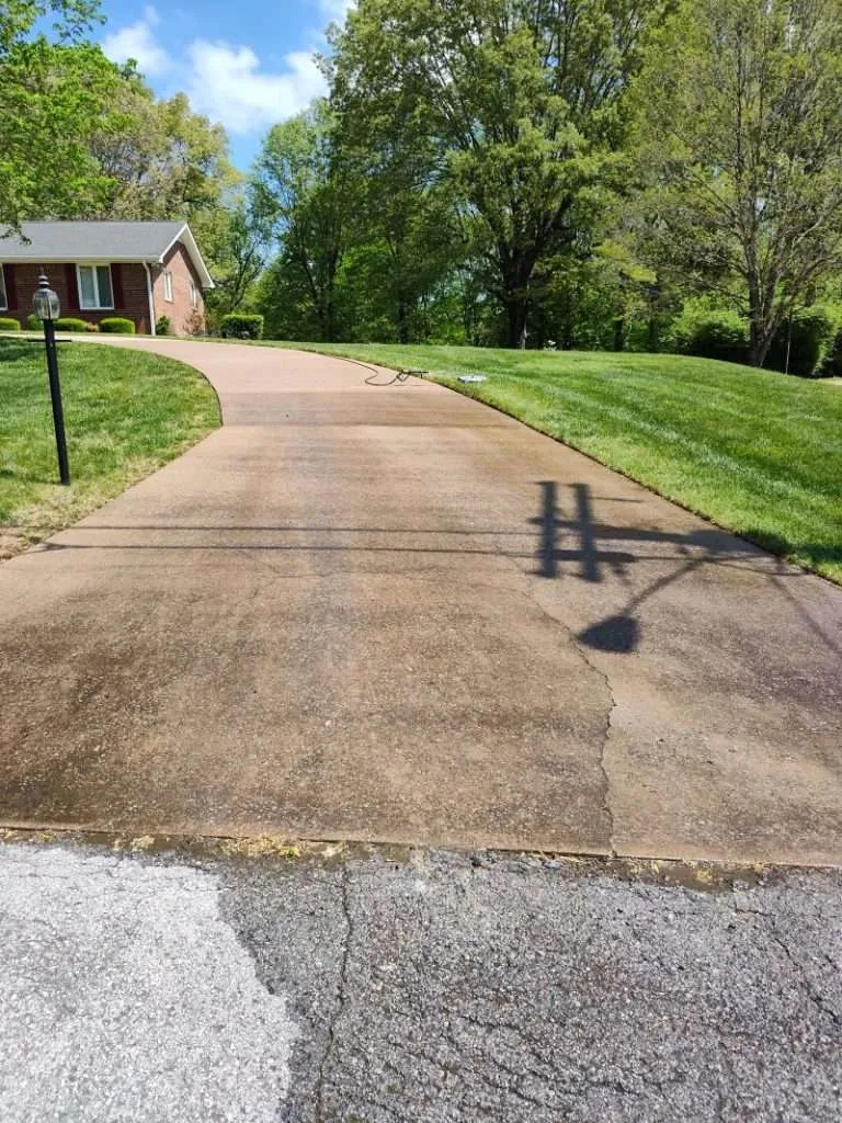 Concrete cleaning in Clarksville TN showing driveway before professional cleaning